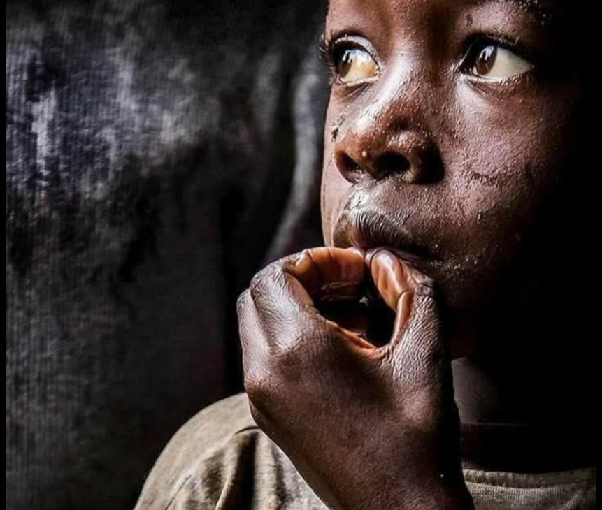Smiling child in a community surrounded by neighbors